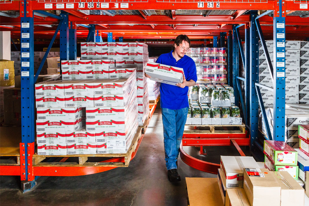 A worker picks cases from Ergo Deep® pallet rack.